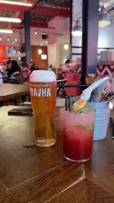 A video review of Pizza Punks in Newcastle, highlighting their Thursday deal which includes a pizza, side, and drink for £24.50 per person. The creator showcases the interior, the menu, and various dishes including a smash burger pizza, buffalo chicken pizza, mac and cheese, and a garlic bomb, alongside a strawberry smash cocktail.