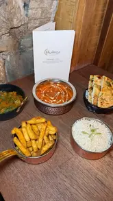 A montage-style reel showcasing the interior and various dishes at Kalinga, an Indian restaurant in Glasgow, featuring close-ups of curries, sides, and the dining area.
