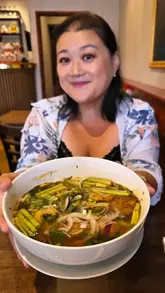 A vlog-style review of Viet House in Bromley, featuring the creator and her auntie trying a wide selection of authentic Vietnamese dishes including papaya salad, banh mi, various noodle soups, banh cuon, and banh xeo. The video highlights the cooking process and provides honest feedback on the flavours.