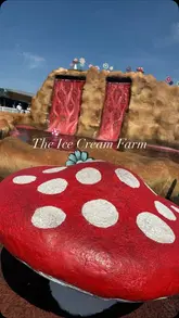 A montage video showcasing a family day out at The Ice Cream Farm, featuring various activities like crazy golf, go-karts, and play areas, alongside a visit to their large ice cream parlour.