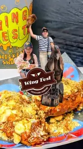 A fast-paced, energetic vlog-style reel covering Wing Fest in Sheffield. The video features two creators sampling various chicken wing vendors, highlighting the festival atmosphere, live music, and arcade games.