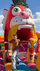 A promotional reel for the Summer Fair at the Trafford Centre, showcasing various fairground rides, a splash pool, a beach area, and character appearances.