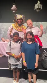 A montage of the Horrible Histories: Awesome Egyptians experience at Battersea Power Station, featuring actors performing sketches, museum artifacts, and children enjoying the interactive show.