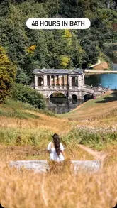 A high-quality, aesthetically pleasing travel shot featuring a person overlooking a scenic landscape in Bath, effectively capturing a 'slow travel' and relaxing atmosphere.