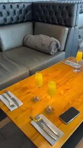 A bright, clean shot of a table setting with mimosas at a country club, capturing a celebratory morning atmosphere.