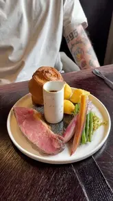 A review of a Sunday roast at Glaschu in Glasgow, highlighting the refined take on Scottish classics like beef and chicken roasts, accompanied by homemade Yorkshire puddings and a notable cheese trolley.