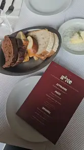 A series of static shots showcasing a meal at BONE in Hoxton, featuring steak, salad, and dessert.