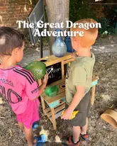 A candid, outdoor shot of two children engaging with an interactive 'dragon potion' activity station at a museum. The image captures a moment of play, highlighting the family-friendly nature of the venue's summer event.