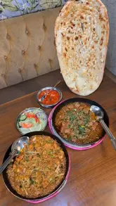 A promotional video for Karahi by Sanam, featuring a tour of the restaurant's interior, a look at the menu, and close-ups of various dishes including freshly made jalebi and sizzling karahi.