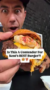 A food review video featuring a creator visiting The Coach Works in Ashford to try the Surf 'N' Burgs menu, specifically highlighting their lobster-topped burger, lobster and crab grilled cheese, and loaded fries.
