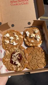 A short, handheld video showcasing a new gluten-free caramel popcorn cookie from The After School Cookie Club, featuring close-up shots of the product.