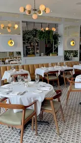 A montage video showcasing the interior and various dishes at Lasan restaurant, featuring Indian cuisine.