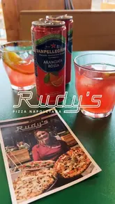A short, music-led montage showcasing the pizza-making process, the interior of the restaurant, and the final dishes served at Rudy's.