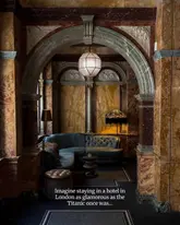 A beautifully composed, atmospheric photograph of an intimate seating nook within the Kimpton Fitzroy hotel, framed by an ornate, historic archway that highlights the venue's luxurious interior design.