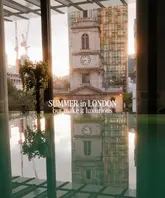 A high-quality, atmospheric shot taken from inside the Pan Pacific London, capturing a reflection of the historic church tower opposite in a water feature, framed by modern architecture. It effectively communicates a sense of luxury and calm within the city.
