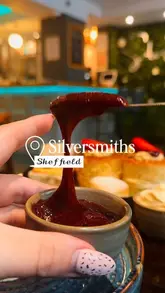 A short, aesthetic montage showcasing an afternoon tea service at Silversmiths in Sheffield, featuring close-ups of tea pouring, jam spreading, and a selection of sandwiches and cakes.