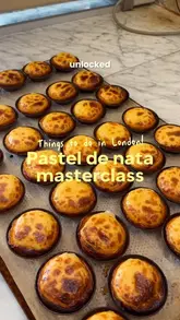 A vlog-style video showcasing a pastel de nata masterclass at Santa Nata in London, featuring the creators learning the baking process and tasting the final product.