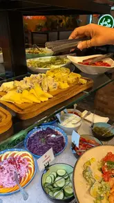 A vlog-style review of an unlimited Mediterranean small plates restaurant, showcasing the ordering process, salad bar, various tapas dishes, and dessert.