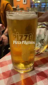 A vlog-style video showing a pizza-making class at Pizza Pilgrims, featuring the process of preparing the dough, adding sauce, and baking the pizza, followed by a taste test.