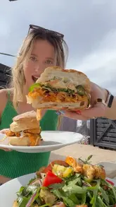 A vlog-style reel featuring two creators visiting Greens Grocers in Leeds, showcasing the shop's organic produce, pantry items, and the outdoor cafe area by the canal where they enjoy food and drinks.