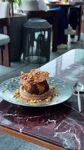 A montage of high-end dishes and interior shots at a London rooftop venue, showcasing the atmosphere and food presentation.