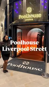 A high-quality, well-lit promotional shot featuring a creator standing in the entrance of Poolhouse London, a venue focused on competitive socialising and drinks in Liverpool Street.