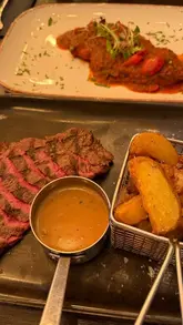 A short video showcasing the 'Express Menu' at Mambo's Express, highlighting the affordability of the two-course deal. The video features shots of the restaurant exterior, the menu, and close-ups of dishes including mozzarella sticks, potato skins, rump steak, and chicken steak.