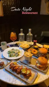 A short, edited reel showcasing a restaurant called Barebone in Dublin, featuring shots of cocktails, burgers, fries, wings, and a chocolate dessert in an intimate, dimly lit setting.