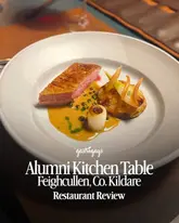 A professional, high-quality food photography shot featuring a beautifully plated duck dish with a potato accompaniment and sauce, presented in a fine dining style. The image is clean, well-lit, and clearly intended to showcase the culinary standard of the venue.
