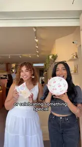 A vlog-style video showing two friends visiting a pottery cafe to paint ceramics, drink spritzes, and eat cake. The video highlights the creative process and the social aspect of the activity.