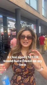 A vlog-style video featuring two creators discovering a hidden chai spot located at the back of a convenience store in Wembley. The video follows them walking through the shop to find the counter, showcasing the food display and the preparation of the chai, followed by a taste test.