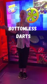 A group of friends visits Golf Fang in Cardiff to experience their bottomless package, which includes unlimited drinks, food, and activities like darts, karaoke, or golf. The video highlights the vibrant, neon-lit atmosphere, the cocktail menu, and the street food options available.
