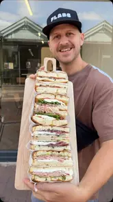 A review-style video showcasing Gino's Neapolitan Bottega in Gravesend, highlighting their freshly baked focaccia sandwiches with imported Italian ingredients.