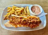 A straightforward, casual food review of a foot-long hot dog served with fries and coleslaw at a pub venue.