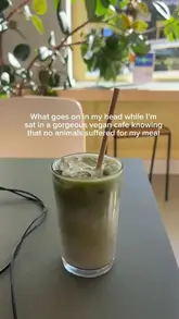 A short, static video showcasing a selection of vegan food and drinks at a cafe, including iced matcha, udon noodles, a soy latte, and a cookie.