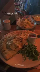 A short, montage-style video showcasing a family meal at a Bella Italia restaurant, highlighting the menu, kids' activities, and promotional offers.