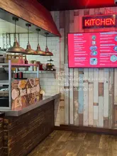 A wide-angle interior shot of a Japanese street food venue, featuring a menu board and service counter, used to promote the location as a destination in Wakefield.