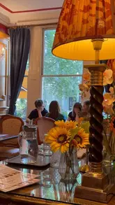 A montage reel showcasing the interior, exterior, coffee, and pastries of Cafe 44 in Kensington, highlighting its cozy Victorian atmosphere.