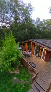 A family travel vlog showcasing a stay at Darwin Forest Lodges in the Peak District, highlighting the lodge amenities, hot tub, and various on-site activities like cycling, swimming, and mini-golf.