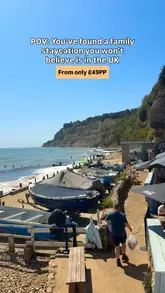 A fast-paced montage showcasing a family holiday on the Isle of Wight, featuring ferry travel, beach days, resort activities like swimming and arcades, and scenic sightseeing spots.