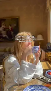 A short, aesthetic video showing a couple having breakfast in a grand, sunlit room with a garden view on their wedding morning. The video focuses on the atmosphere and the romantic setting rather than the food itself.