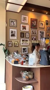 A short, aesthetic montage showcasing the interior and exterior of BRÜE coffee shop on Fulham Road, London, featuring shots of the coffee machine, decor, and a finished drink.