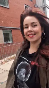 A clear, well-lit, and engaging selfie-style shot of a creator, likely serving as an introduction to a restaurant review video. The image is technically sound with good focus and natural lighting.