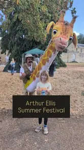 A vlog-style video showcasing the Arthur Ellis Summer Festival in Milton Keynes, highlighting various free family-friendly activities including face painting, donut decorating, crafts, and games, while promoting the mental health charity behind the event.