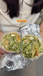 Two creators visit a new branch of Czer to try their viral Caesar salad wrap, documenting the ordering process, the unique addition of crisps to the wrap, and their taste test reaction.