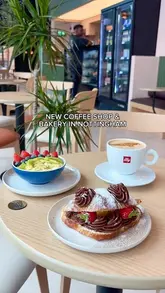 A promotional montage video for the opening of a new AM Coffee & Bakery location in Nottingham, featuring shots of the interior, the display case, and specific menu items like a matcha breakfast bowl and a Nutella strawberry croissant.