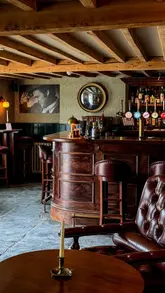A promotional reel for The Norman Knight, a pub in the Cotswolds, featuring a variety of dishes including a Sunday roast, desserts, and drinks, alongside shots of the interior and outdoor garden seating.