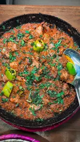 A montage video showcasing various Pakistani dishes, including Karahi, mixed grill, and traditional sweets, at Karahi by Sanam in Manchester, along with glimpses of the restaurant's interior.