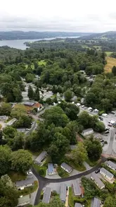 A family travel vlog showcasing a stay at Skelwith Fold holiday park in the Lake District, highlighting the accommodation pods, nature trails, playgrounds, and the peaceful woodland setting.