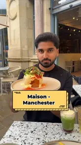 A video review of Maison, a Parisian-style cafe in Manchester, showcasing their brunch menu, pastries, and drinks. The creator highlights various dishes including eggs benedict, toasties, and smash burgers, while providing a tour of the venue.